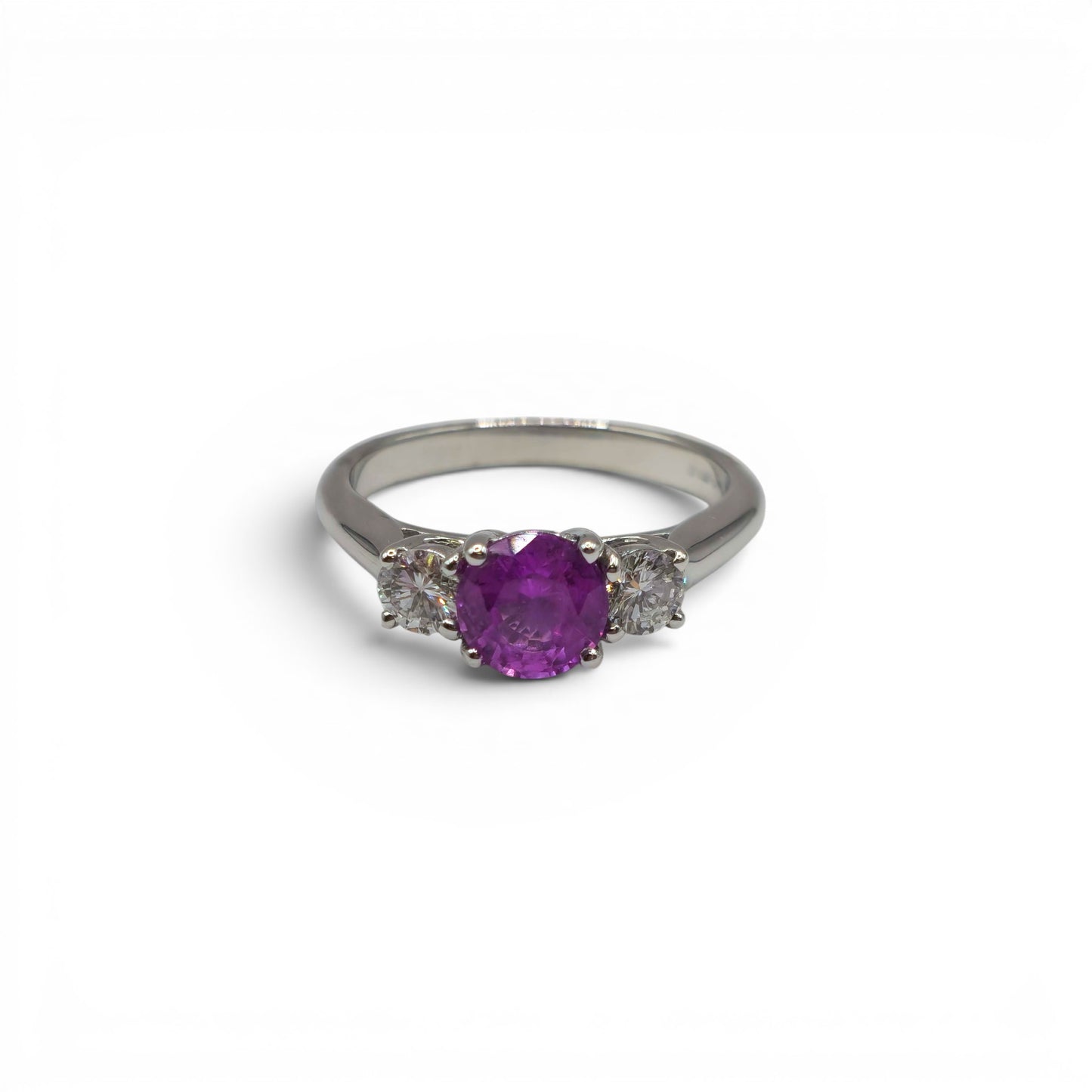 18ct white gold pink sapphire and diamond ring by Reeves and Sons, featuring a pink sapphire center with sparkling diamonds.