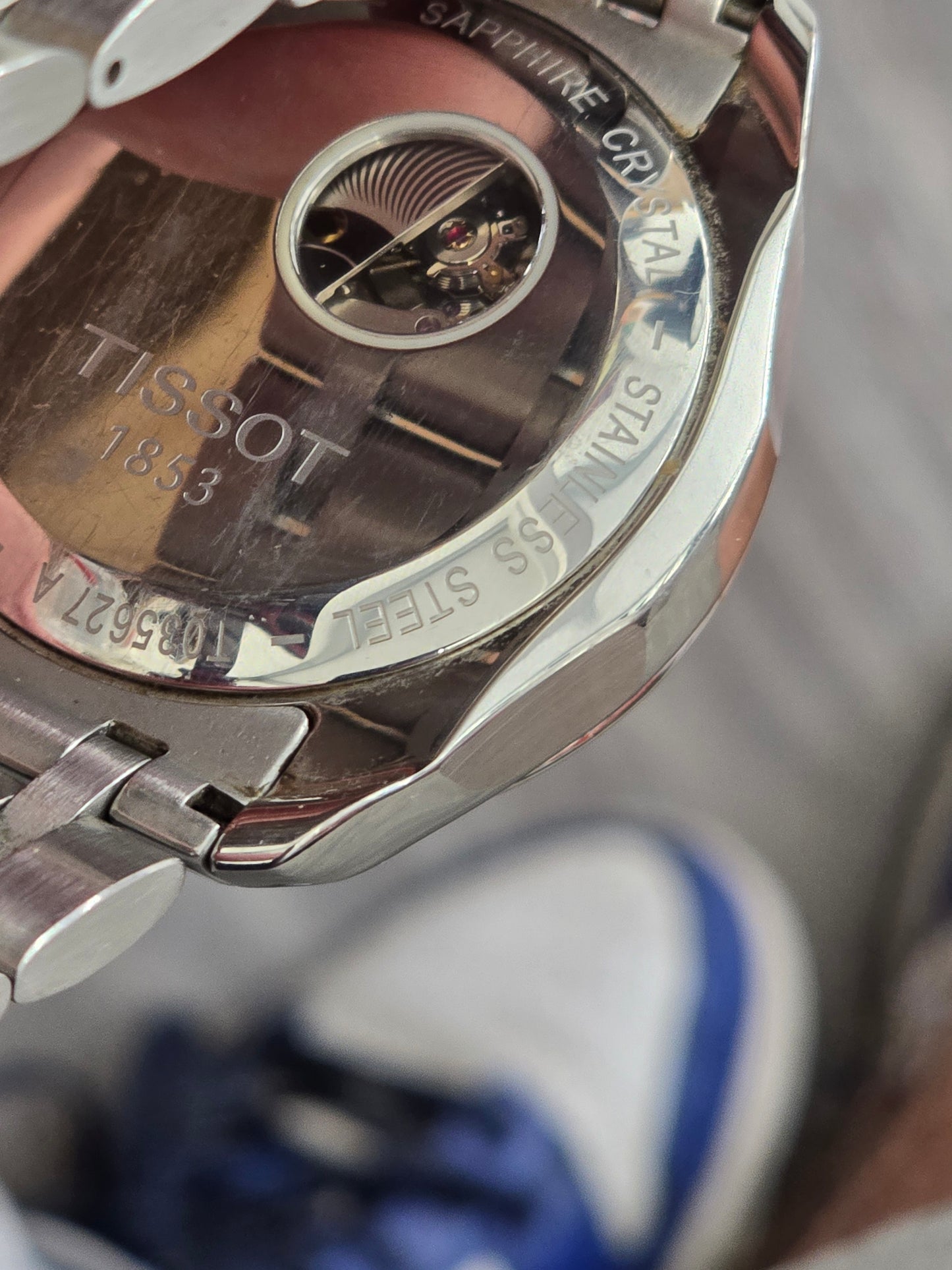 Reeves and Sons Tissot 1853 automatic chronograph watch with black dial and stainless steel bracelet, detailed close-up image