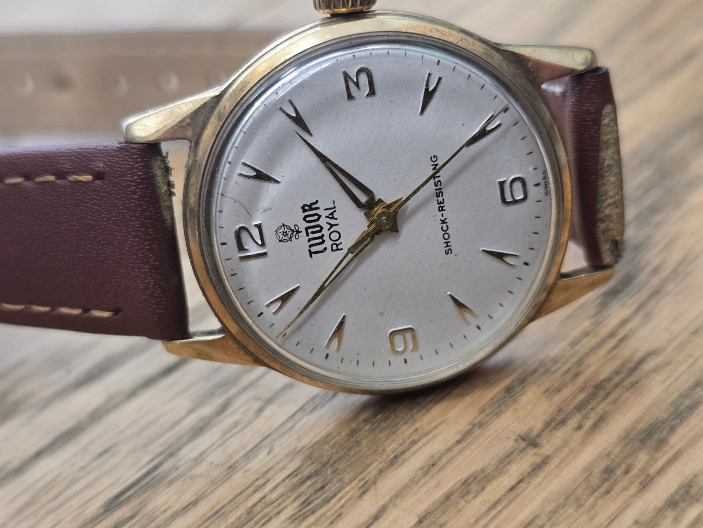 9ct yellow gold Tudor Royal watch with brown leather strap, showcasing classic design and elegant timepiece features.