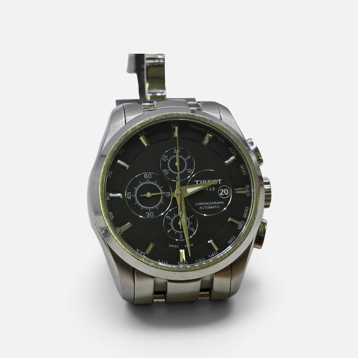 Tissot 1853 automatic chronograph watch with black dial and stainless steel bracelet, showcasing a sleek, modern design.