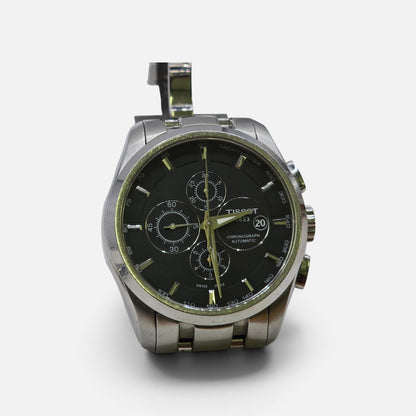 Tissot 1853 automatic chronograph watch with black dial and stainless steel bracelet, showcasing a sleek, modern design.