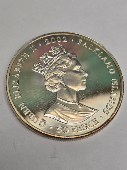 Silver 50 pence golden jubilee coin from 2002 by Reeves and Sons, featuring detailed commemorative design.
