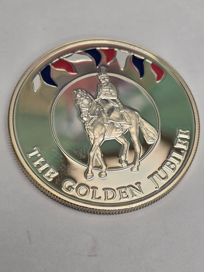 Silver 50 pence golden jubilee coin from 2002 by Reeves and Sons, showing detailed designs on the coin's surface.