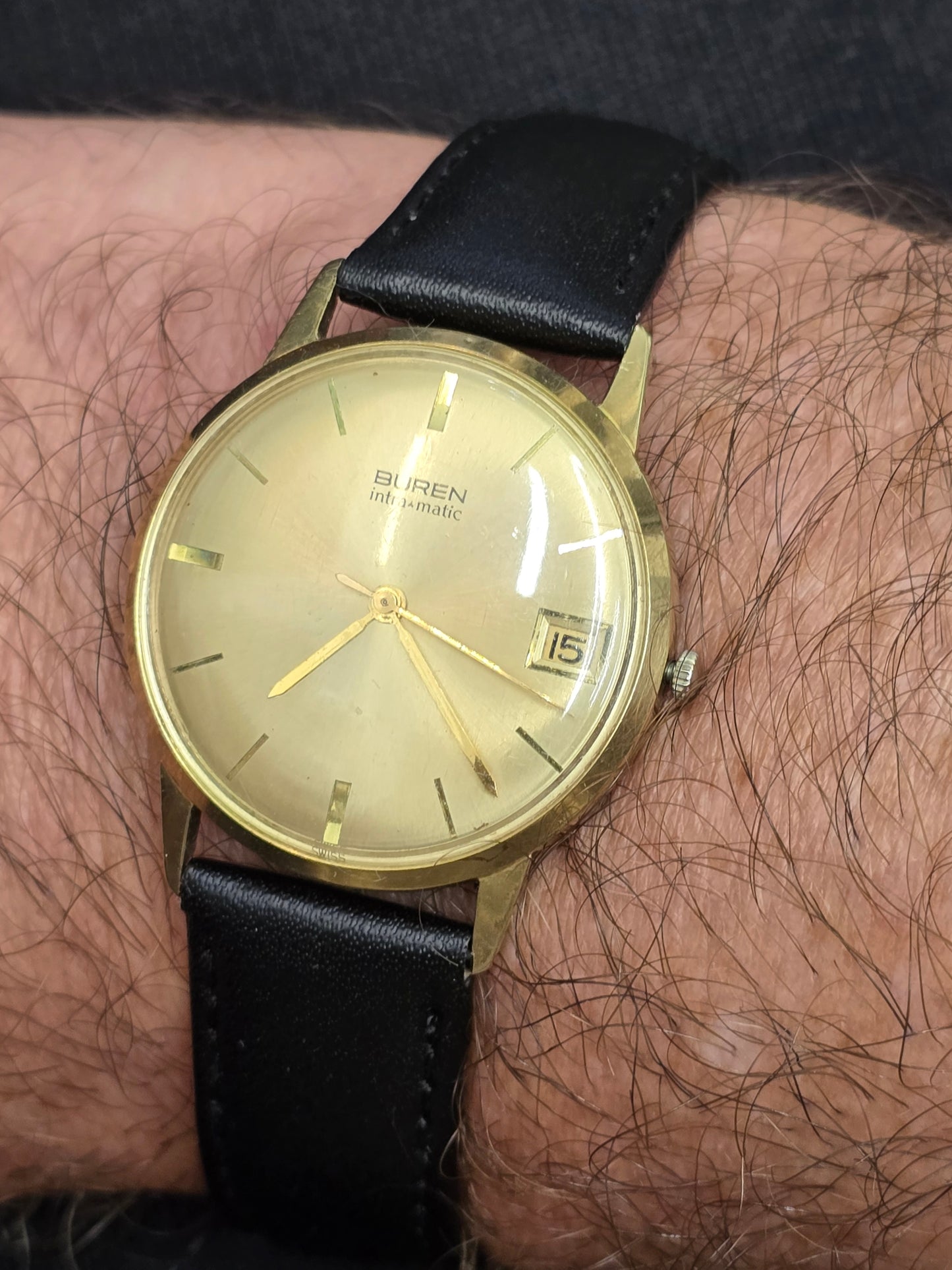 Reeves and Sons Vintage Buren Intra-Matic automatic men's watch with gold plating, sunburst dial, and date feature.