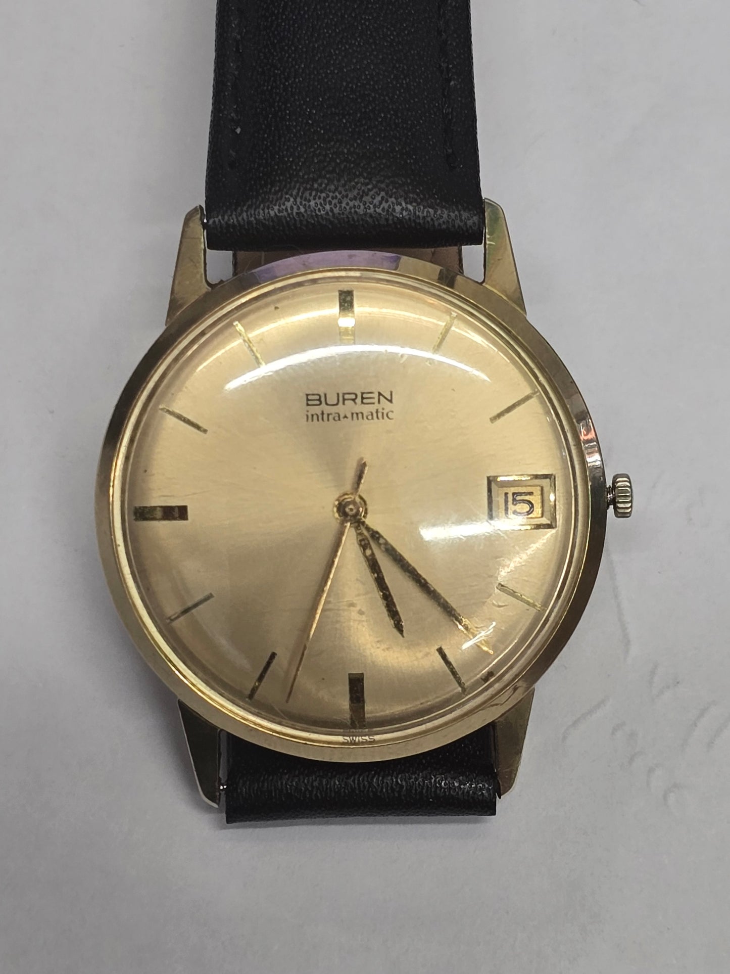 Vintage 9ct yellow gold Buren Intra-Matic automatic men's Swiss watch with classic design and gold-tone dial.