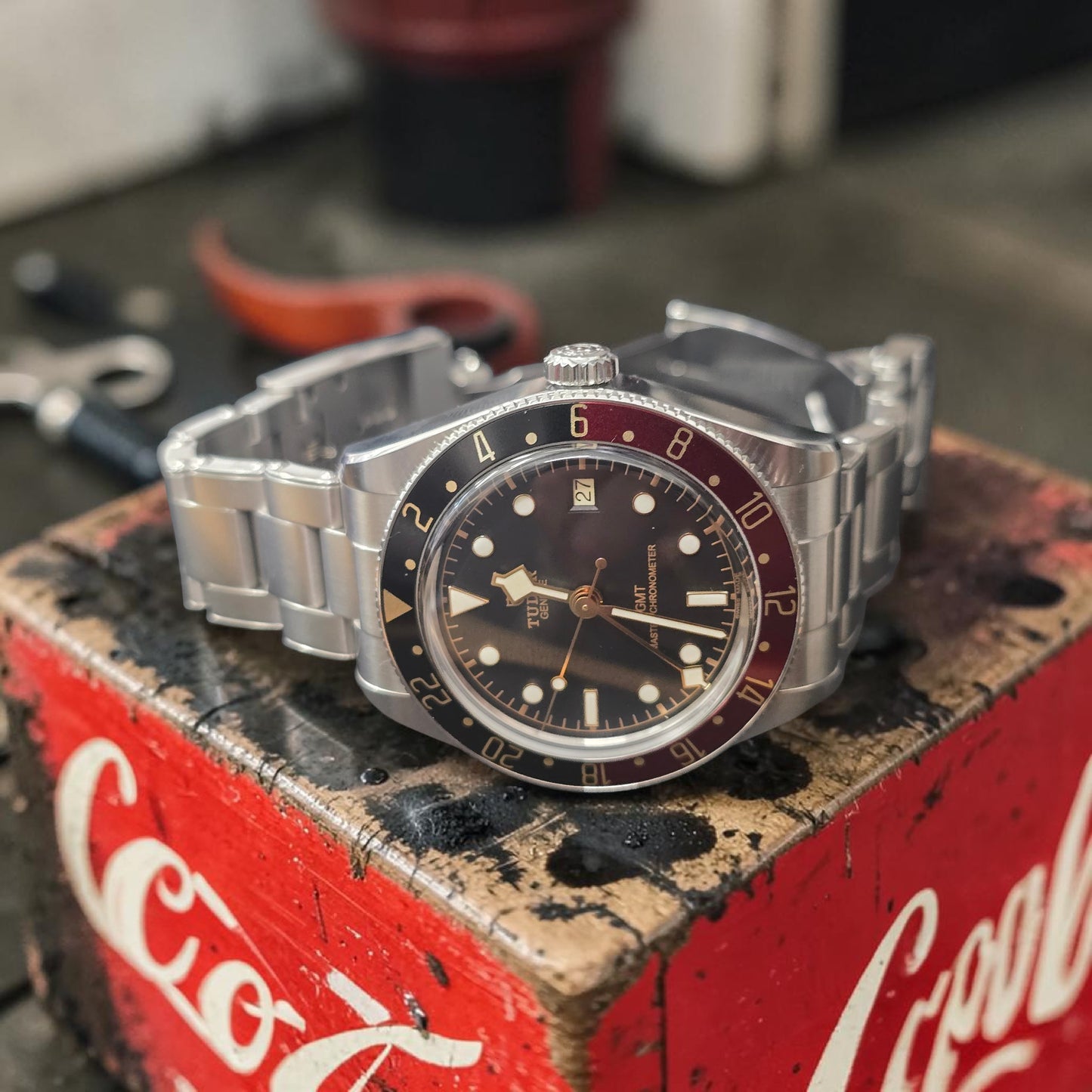 Reeves and Sons Tudor Black Bay 58 GMT Coke fullset watch with black and red bezel, stainless steel bracelet, front view.