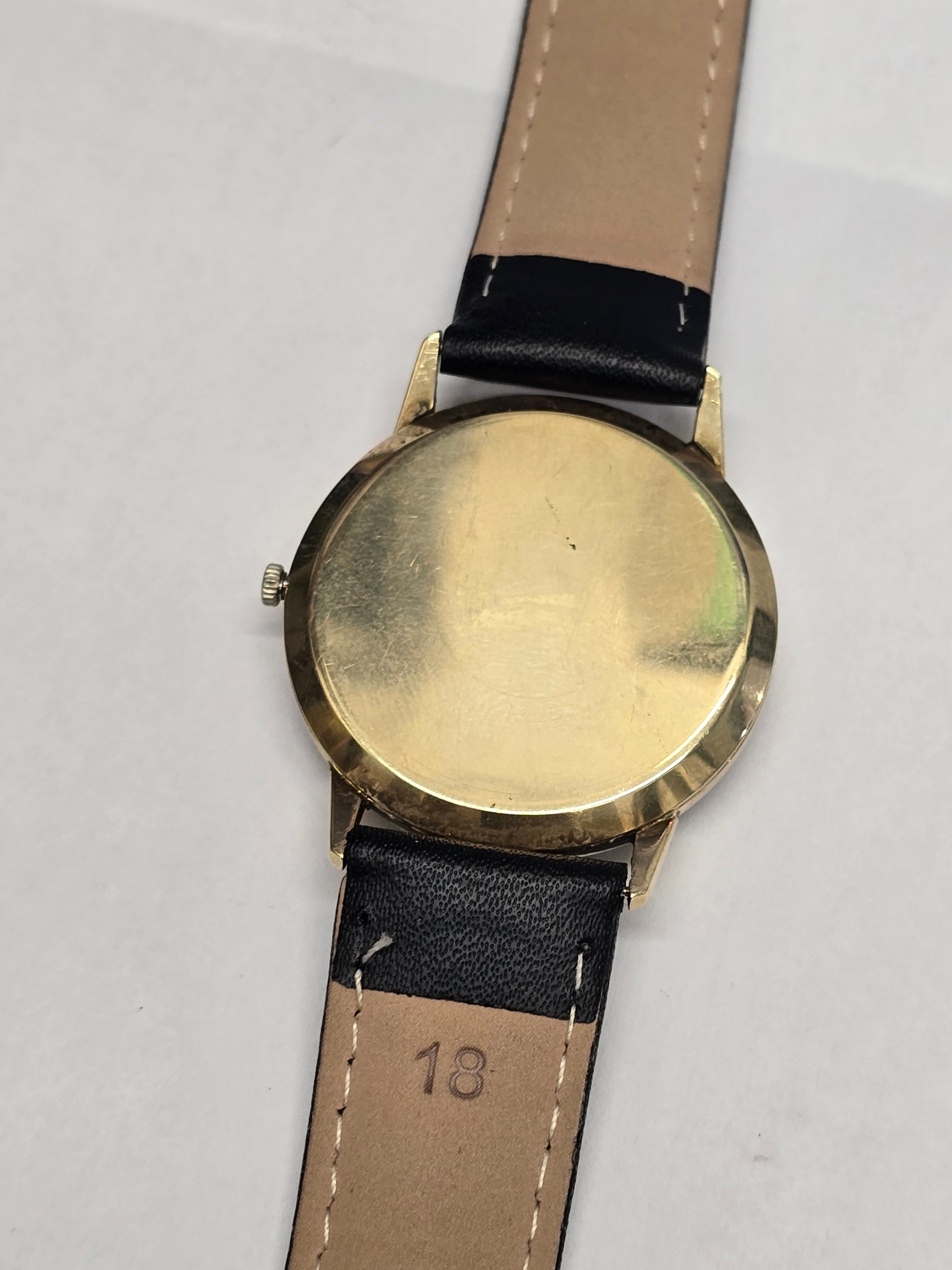 Vintage Reeves and Sons Buren Intra-Matic gold plated men's watch with sunburst dial and date, showcasing classic watch design.