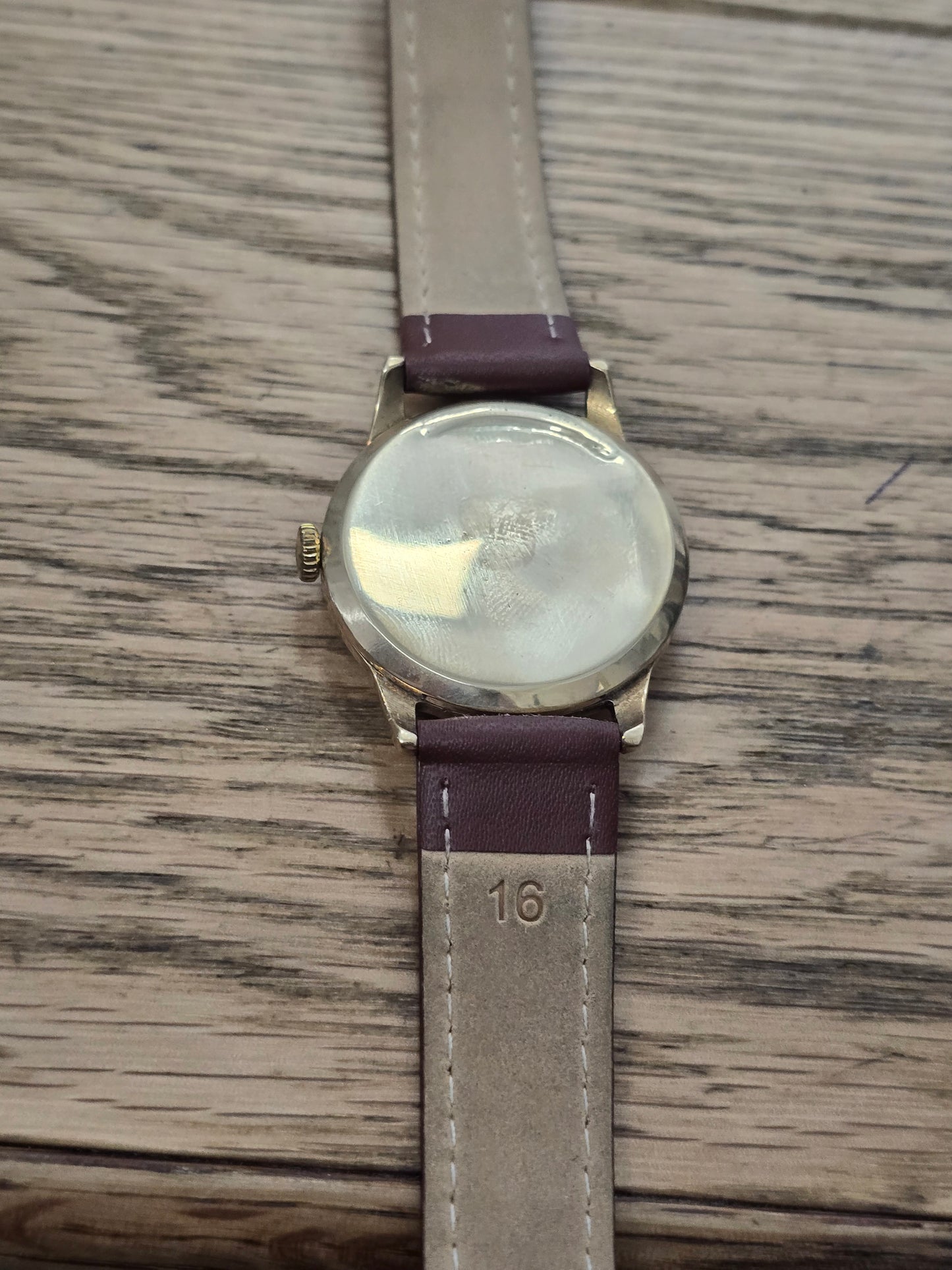 9ct yellow gold Tudor Royal watch with a classic round face on a brown leather strap, featuring elegant detailing.