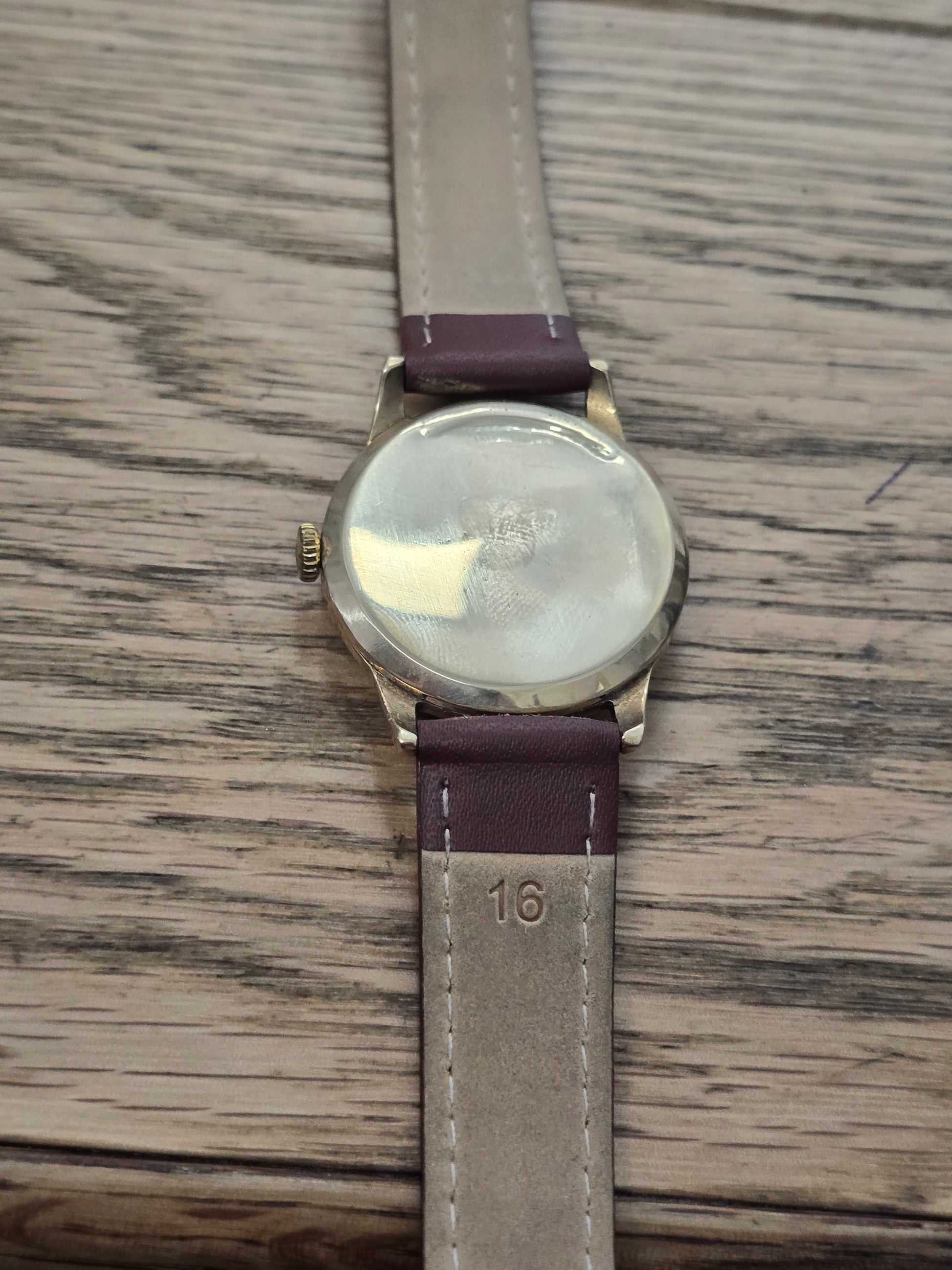 9ct yellow gold Tudor Royal watch with a classic round face on a brown leather strap, featuring elegant detailing.