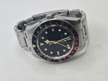 Tudor Black Bay 58 GMT Coke fullset watch from 2024 with black and red bezel, stainless steel case, and bracelet.