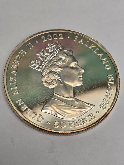 Silver 50 pence coin celebrating the 2002 Golden Jubilee, featuring detailed designs, minted by Reeves and Sons.