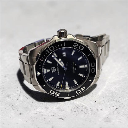 TAG Heuer Aquaracer 300 meters watch with black dial, stainless steel case, and rotating bezel.