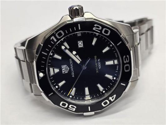 TAG Heuer Aquaracer 300 meters watch with black dial, stainless steel bracelet, and unidirectional bezel.