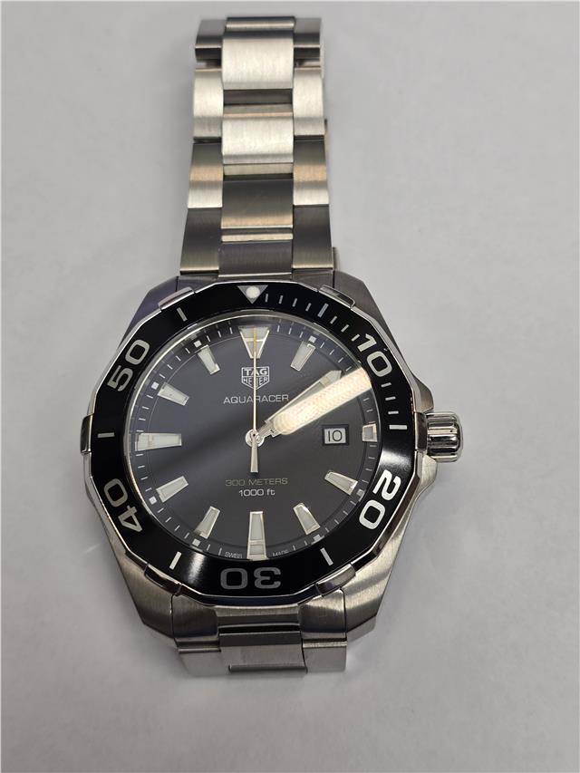 Tag Heuer Aquaracer 300 meters watch with black dial and stainless steel bracelet, suitable for diving and water sports.