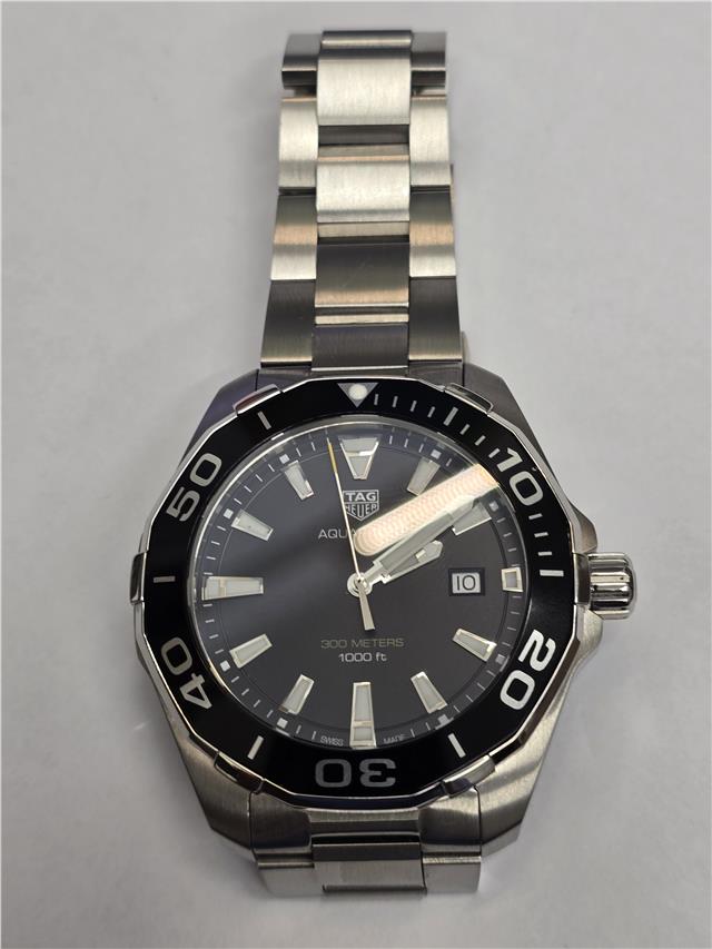TAG Heuer Aquaracer 300 Meters watch with black dial and stainless steel bracelet, suitable for diving and water sports.