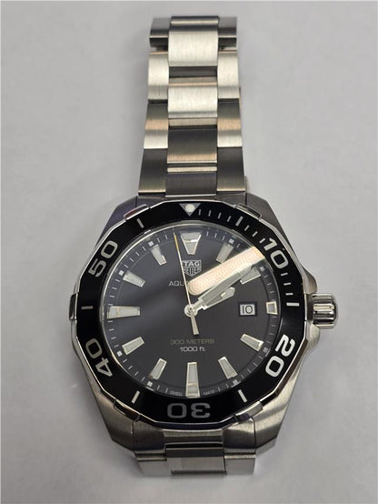 TAG Heuer Aquaracer 300 Meters watch with black dial and stainless steel bracelet, suitable for diving and water sports.