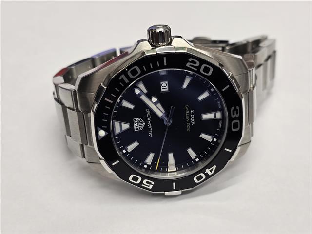 TAG Heuer Aquaracer 300 meters watch with black dial, stainless steel band, and unidirectional bezel.