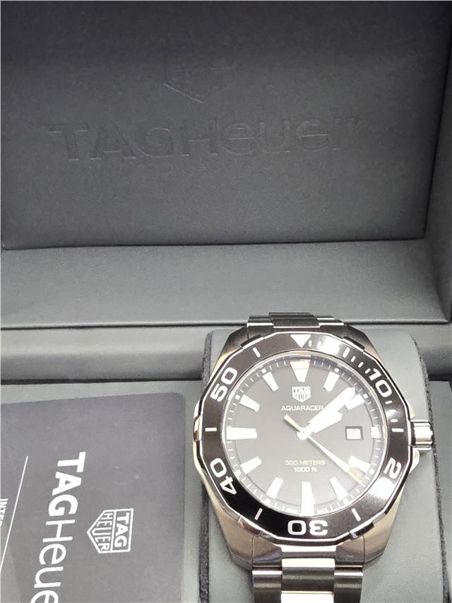 TAG Heuer Aquaracer 300 meters dive watch with black dial and stainless steel band, designed for underwater performance