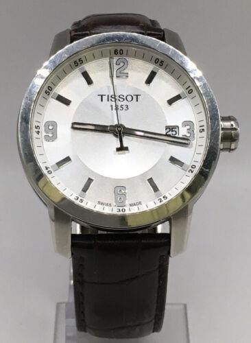 Elegant Tissot men's watch with a stainless steel band and classic dial, showcasing the Tissot brand and sophisticated design.