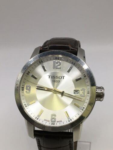 Elegant Tissot men's watch with stainless steel band and round dial, showcasing classic design and Swiss craftsmanship.