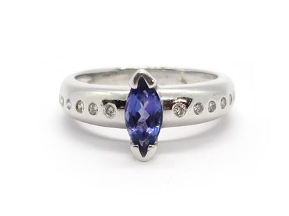 14ct tanzanite and diamond ring with a gold band, featuring a vibrant tanzanite gemstone surrounded by sparkling diamonds.