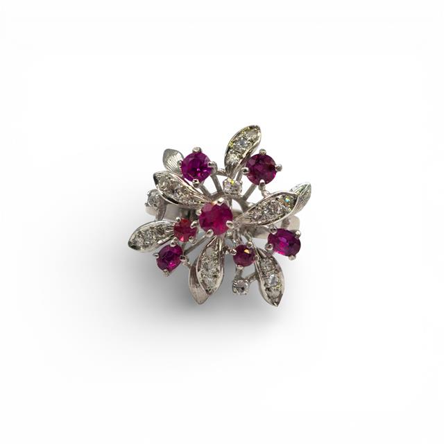 14ct white gold ruby and diamond ring with a central ruby gemstone and sparkling diamonds, elegant jewelry piece.
