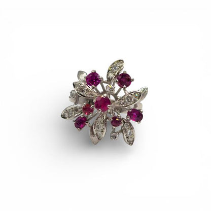 14ct white gold ruby and diamond ring with a central ruby gemstone and sparkling diamonds, elegant jewelry piece.