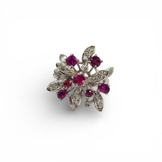 14ct white gold ruby and diamond ring with a central ruby gemstone and sparkling diamonds, elegant jewelry piece.