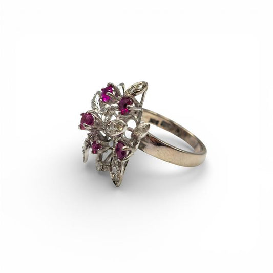 14ct white gold Ruby and diamond ring with a central ruby surrounded by sparkling diamonds, elegant jewelry piece.