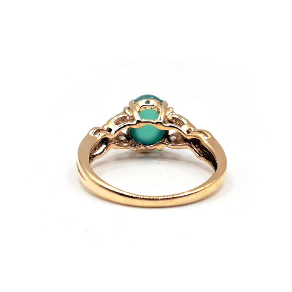 14ct yellow gold ring featuring a 1.15 carat chrysoprase gemstone accented with 0.20 carat diamonds.