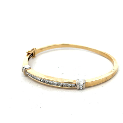 14ct yellow gold diamond bangle bracelet with 1 carat total weight, featuring sparkling diamonds and a sleek, elegant design.