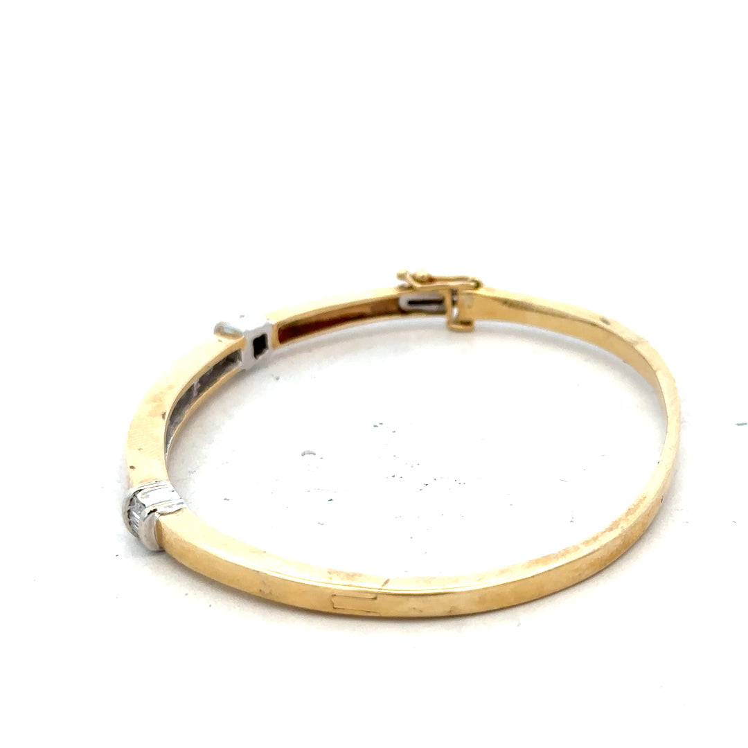 14ct yellow gold diamond bangle bracelet with 1 carat total weight, featuring sparkling diamonds and a sleek design.