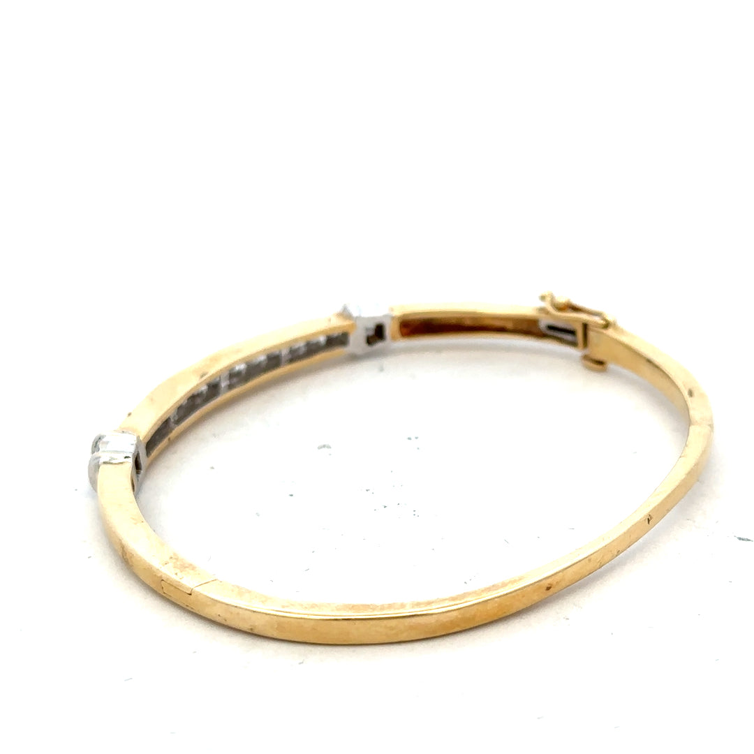 14ct yellow gold diamond bangle bracelet with 1 carat total weight and intricate design, weighing 17.5 grams.