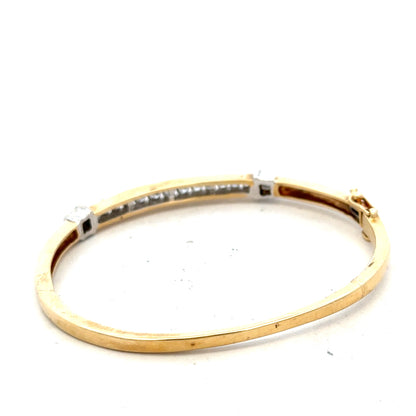 14ct yellow gold diamond bangle bracelet with 1 carat total weight, featuring sparkling diamonds and a sleek gold design.