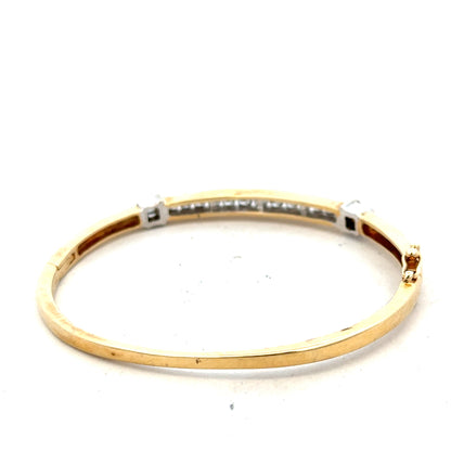 14ct yellow gold diamond bangle bracelet with 1 carat total weight, featuring sparkling diamonds and a sleek design.