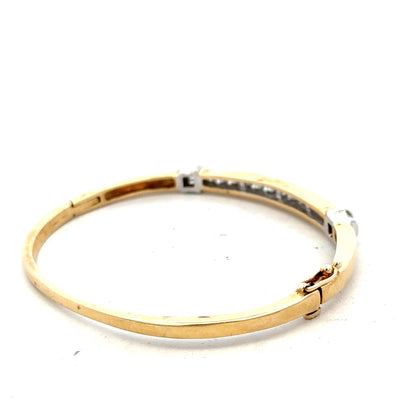 14ct yellow gold diamond bangle bracelet with 1 carat diamonds, weighing 17.5g, unbranded jewelry piece.