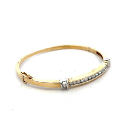 14ct yellow gold diamond bangle bracelet with 1 carat of diamonds and a weight of 17.5g, featuring elegant craftsmanship.