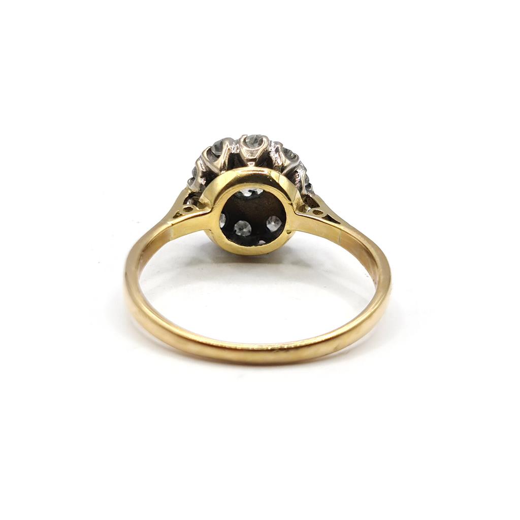 Elegant 18ct gold diamond cluster ring with 0.55 carat total weight, featuring a sparkling arrangement of diamonds.