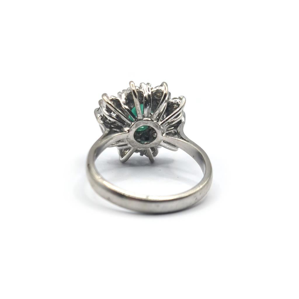 Elegant unbranded 18ct gold ring featuring a 0.65 carat emerald and 1.15 carat diamond centerpiece.
