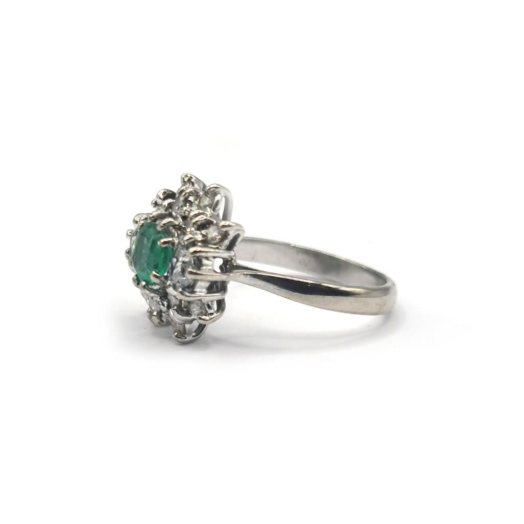 Elegant unbranded 18ct gold ring featuring a 0.65ct emerald and 1.15ct diamond accent, showcasing fine gemstone craftsmanship.
