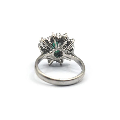 18ct gold ring with a 0.65 carat emerald and 1.15 carat diamond, featuring a classic design and sparkling gemstone accents.