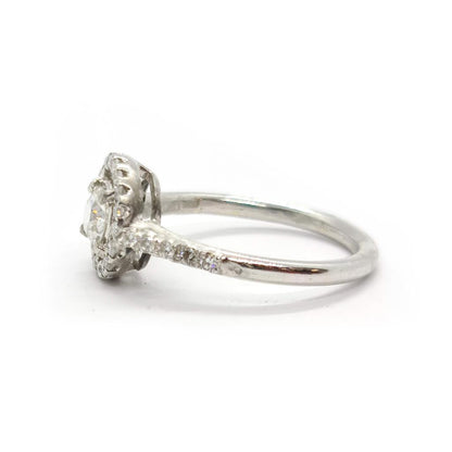 18ct gold diamond halo ring with 0.80ct center diamond and intricate halo setting, elegant and sparkling jewelry piece
