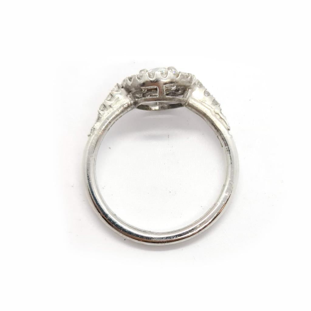 18ct gold diamond halo ring with 0.80ct total carat weight featuring a sparkling center stone and intricate band design.