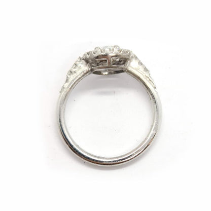 18ct gold diamond halo ring with 0.80ct total carat weight featuring a sparkling center stone and intricate band design.