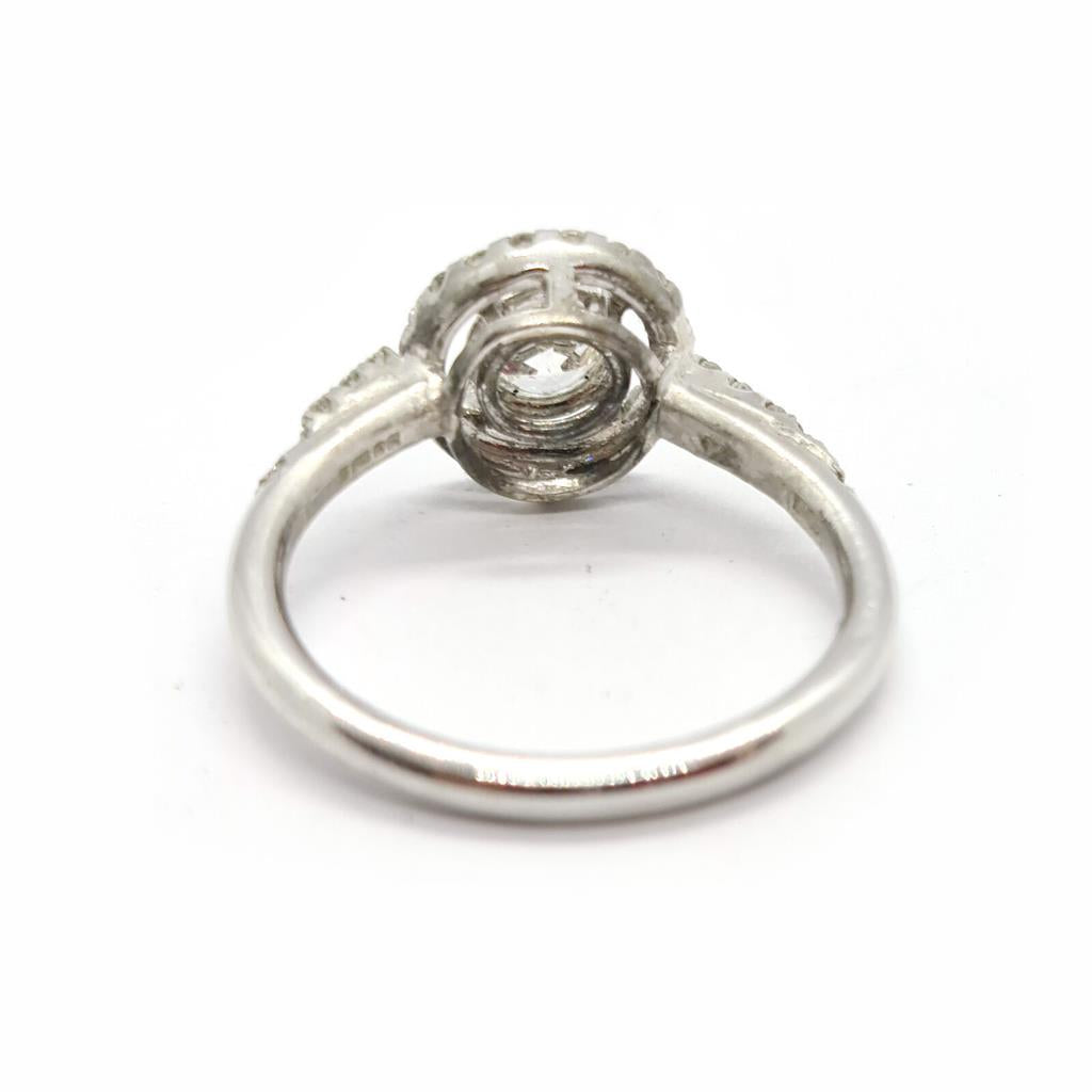 18ct gold diamond halo ring with 0.80ct central diamond and surrounding smaller diamonds, elegant jewelry accessory.