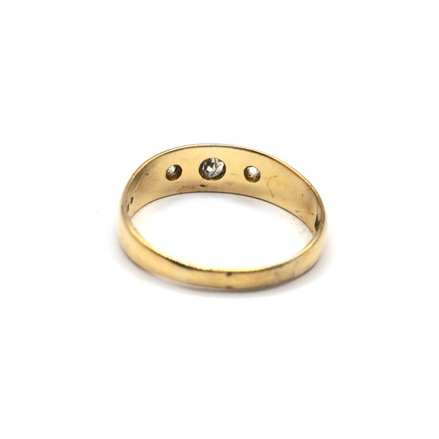 Unbranded 18ct diamond ring with a sparkling central diamond and a sleek band, displayed on a neutral background.