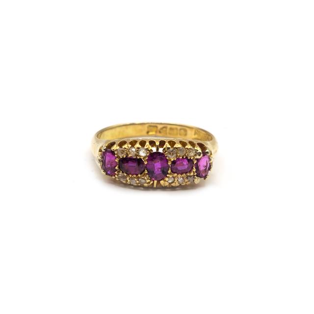 18ct ruby and diamond ring with a gold band, featuring a central ruby surrounded by sparkling diamonds.