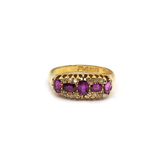 18ct ruby and diamond ring with a gold band, featuring a central ruby surrounded by sparkling diamonds.