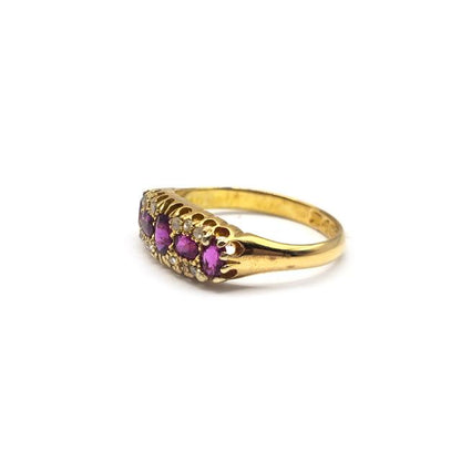 18ct ruby and diamond ring featuring a central ruby gemstone surrounded by sparkling diamonds, set in a classic ring design.