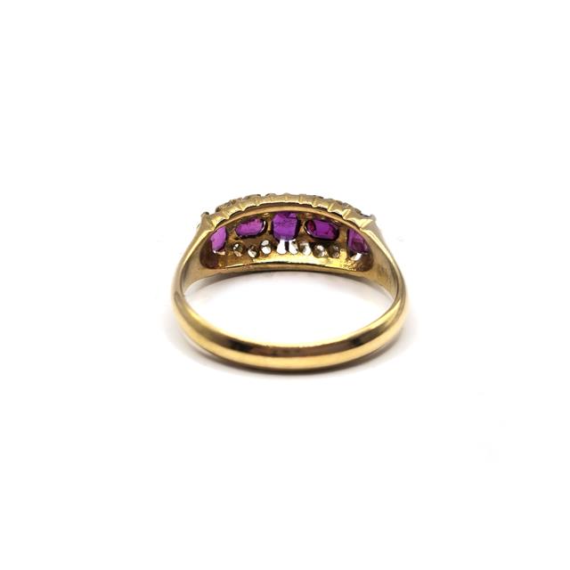 18ct ruby and diamond ring featuring a central ruby surrounded by sparkling diamonds, set in a sleek band.